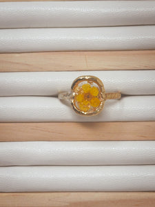 Gold plated ring coated in resin with real pressed yellow flower cast inside with resin.
