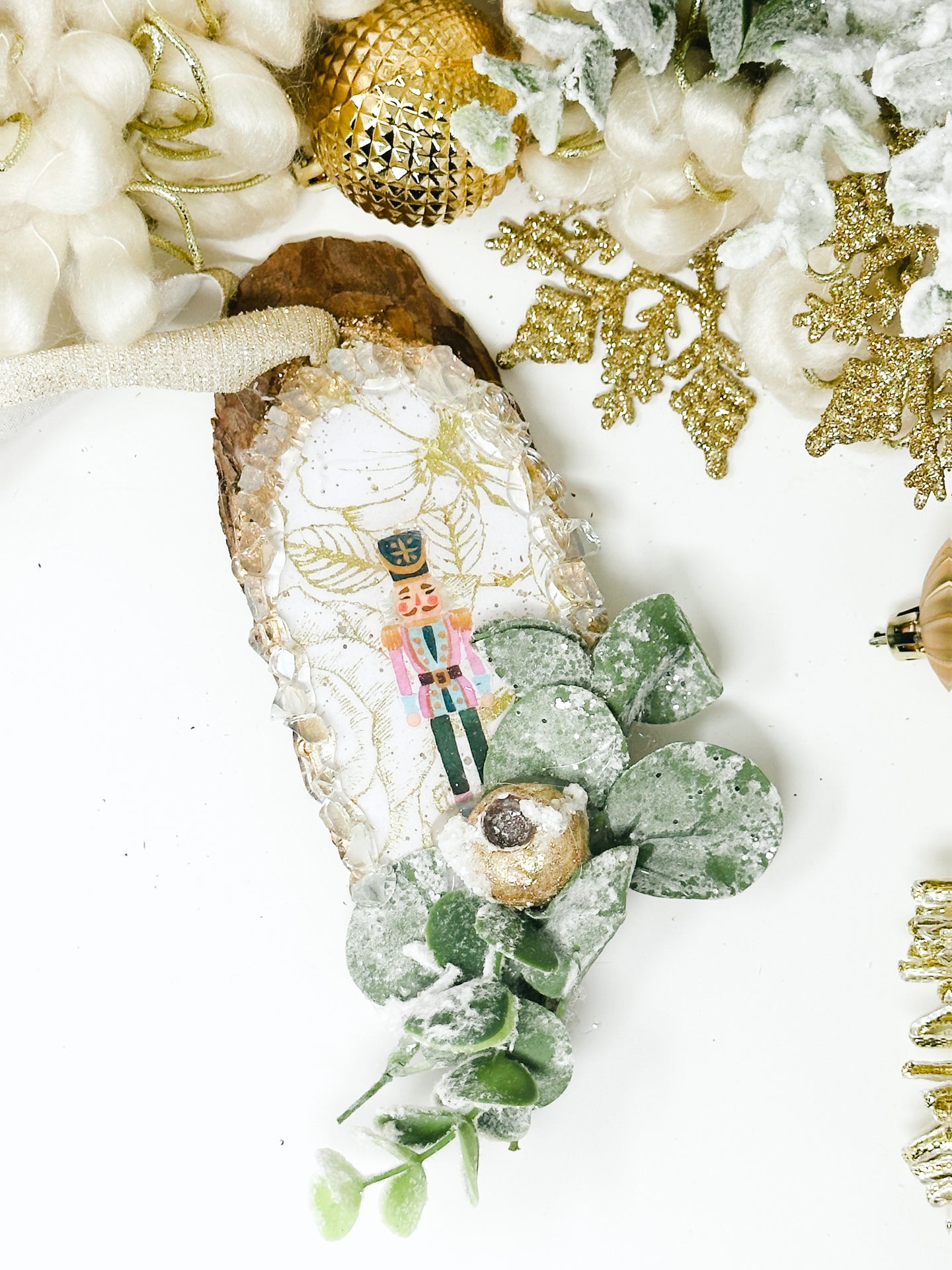 Modern Nutcracker Over Gold Foiled Paper with Foliage