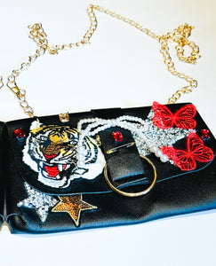 Faux Leather small clutch with fun patches and a classy gold chain for a strap.