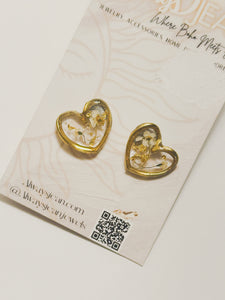 Brass hearts filled with resin and real pressed flowers.